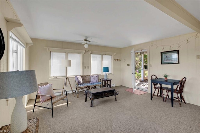 living area featuring carpet floors and ceiling fan