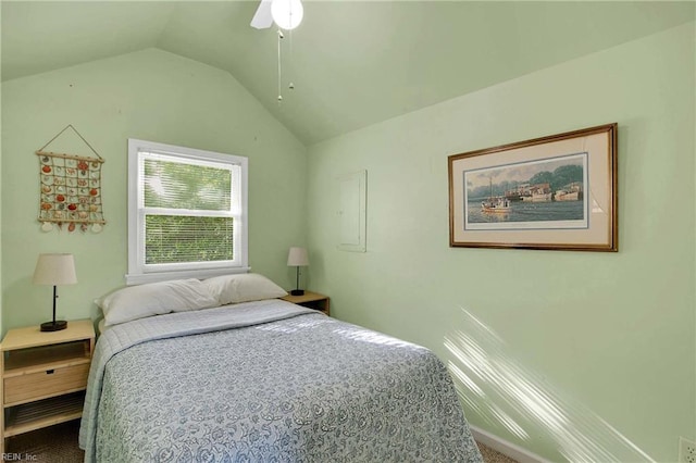 bedroom with a ceiling fan, vaulted ceiling, and carpet flooring