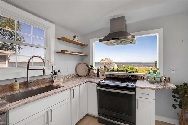 kitchen featuring vaulted ceiling, stainless steel electric range, a sink, ventilation hood, and white cabinets