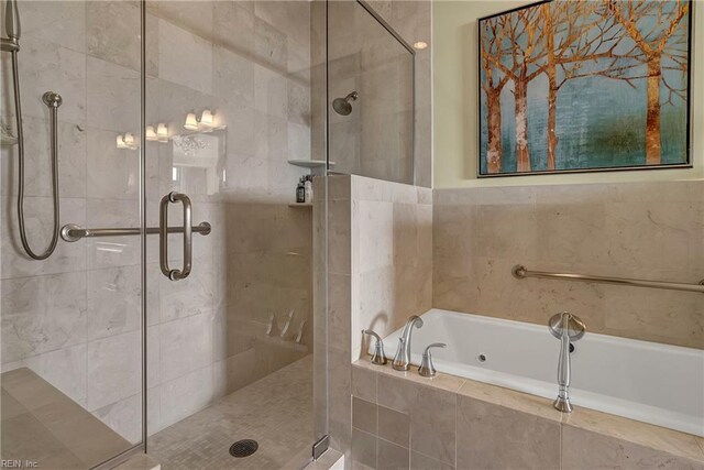 bathroom featuring a bath and a stall shower