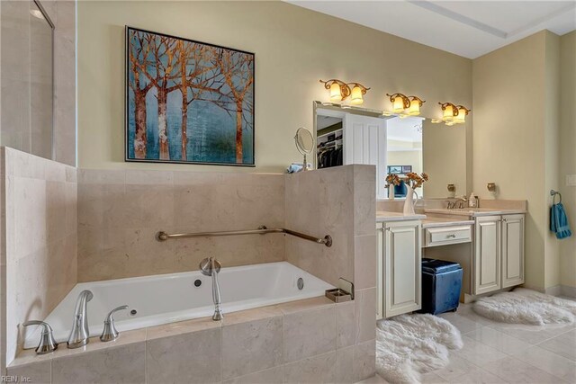 bathroom with a garden tub and vanity