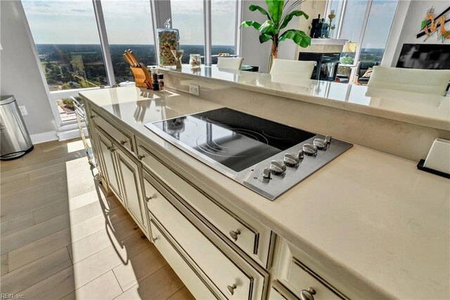 kitchen featuring light countertops, black electric cooktop, and plenty of natural light
