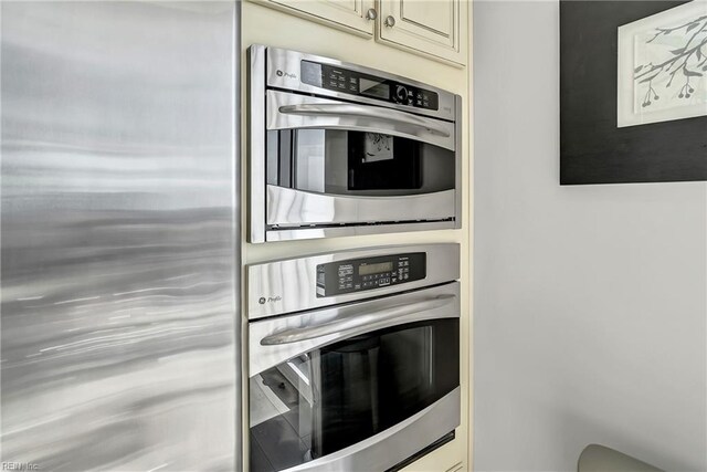 kitchen with appliances with stainless steel finishes and cream cabinetry