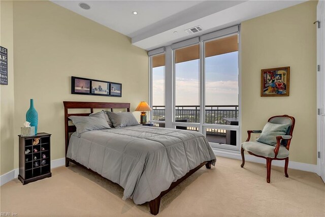 bedroom with visible vents, baseboards, light carpet, and access to exterior