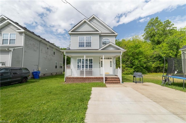 view of front of home with a trampoline, a porch, and a front yard