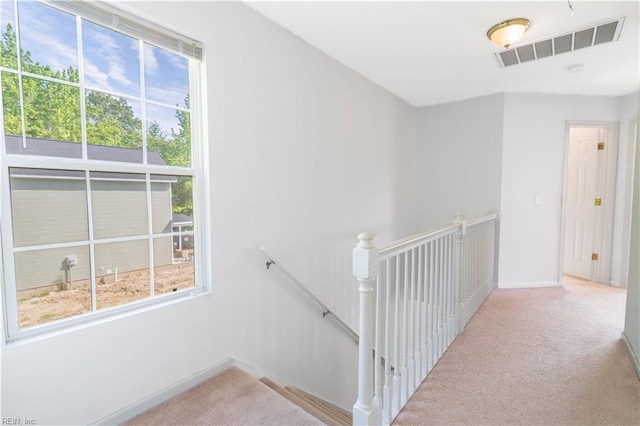 stairs featuring baseboards, carpet flooring, and visible vents