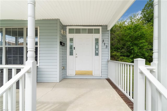 view of exterior entry featuring a porch