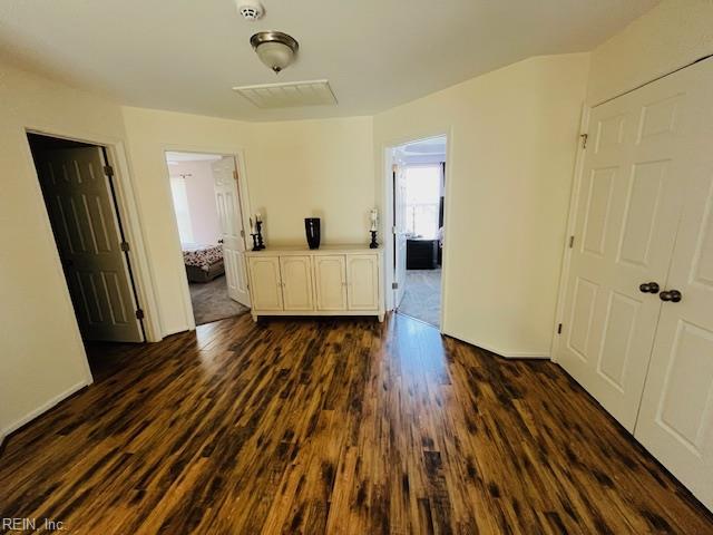 unfurnished room with dark wood-type flooring