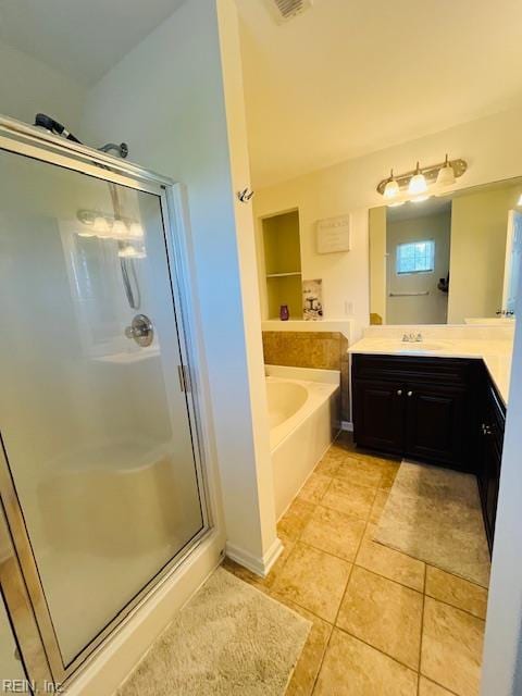 full bathroom featuring vanity, tile patterned floors, a garden tub, and a stall shower