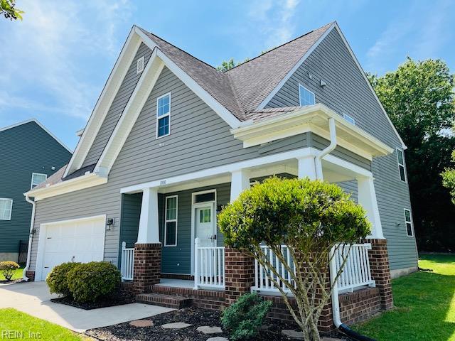 craftsman house with covered porch, brick siding, roof with shingles, and a garage