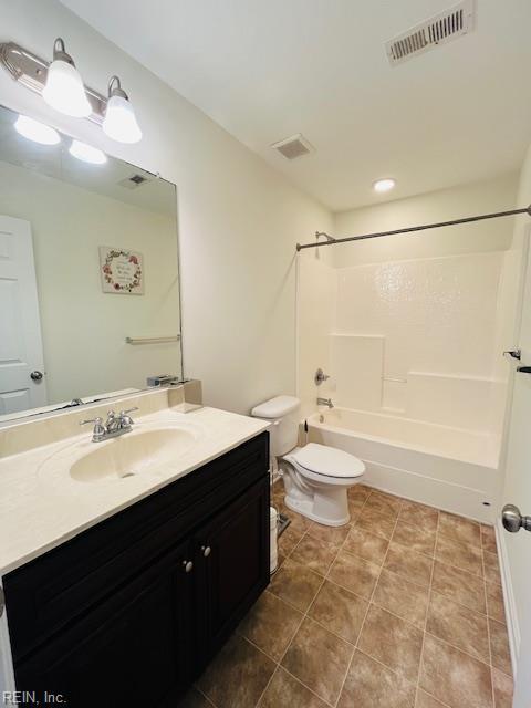 bathroom with visible vents, vanity, toilet, shower / tub combination, and tile patterned floors