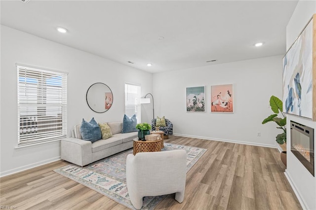 living area featuring recessed lighting and light wood finished floors