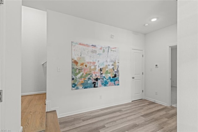 empty room featuring baseboards and wood finished floors