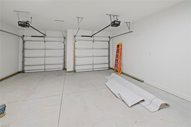 garage with a garage door opener and baseboards