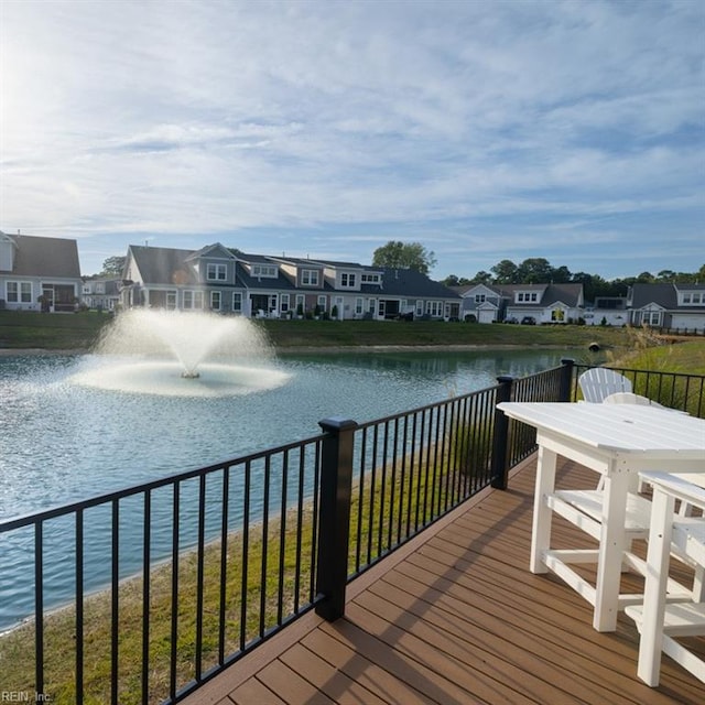 wooden terrace with a residential view and a water view
