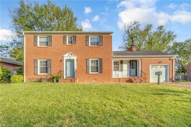 colonial inspired home with a chimney, brick siding, a front lawn, and a garage