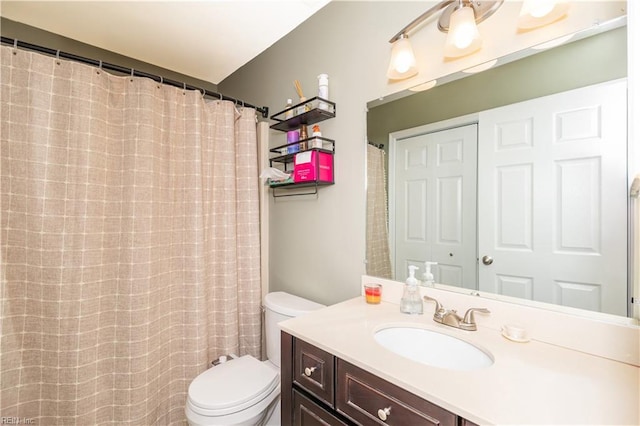 bathroom with toilet and vanity
