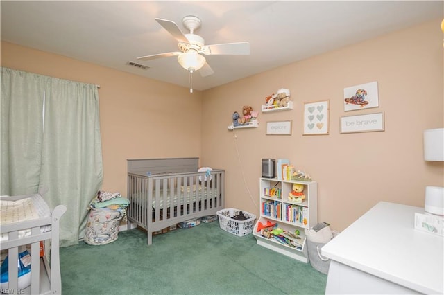 bedroom with carpet floors, a ceiling fan, a nursery area, and visible vents