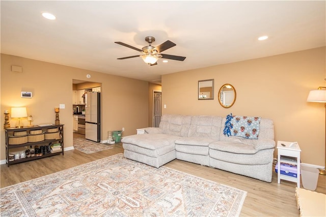 living area featuring recessed lighting, baseboards, a ceiling fan, and light wood-type flooring