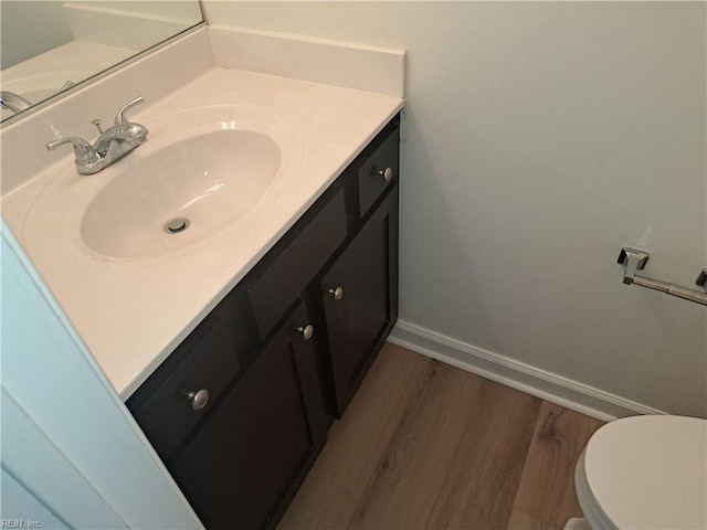5541 Old Guard Cres, Virginia Beach, VA 23462 - half bath with vanity, baseboards, toilet, and wood finished floors