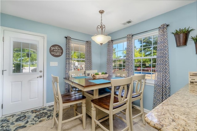 dining space with visible vents, baseboards, and light tile patterned floors