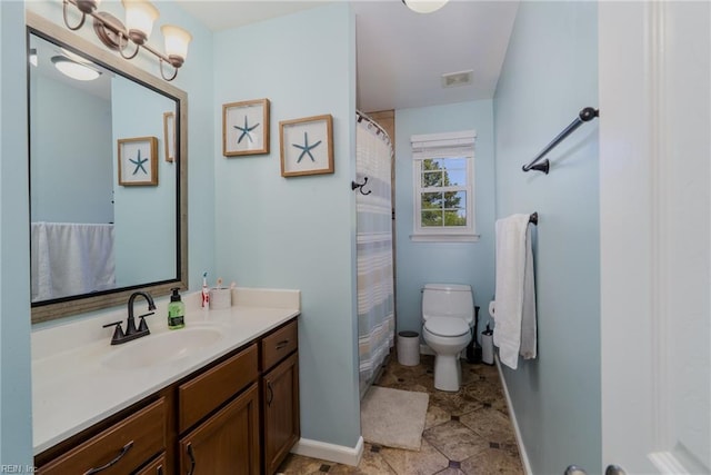 bathroom with toilet, baseboards, visible vents, and vanity