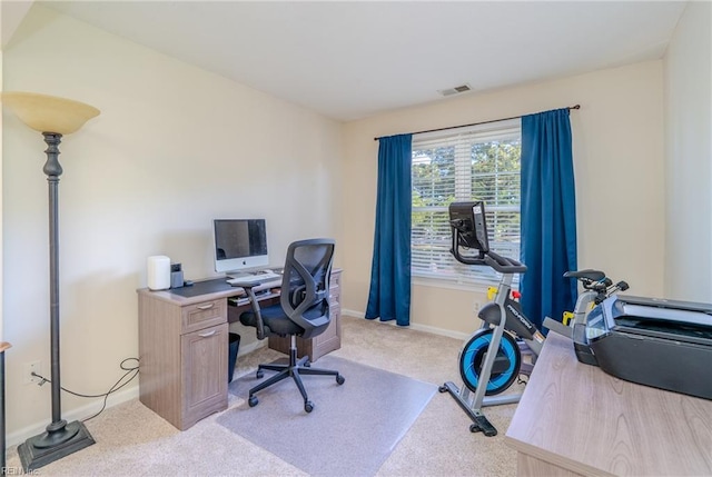 office featuring visible vents, baseboards, and light colored carpet