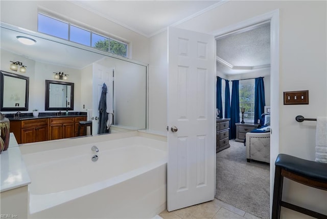 full bathroom with crown molding, tile patterned flooring, a bath, and vanity