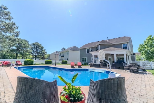 view of pool with a fenced in pool, fence, an outdoor hangout area, and a patio area