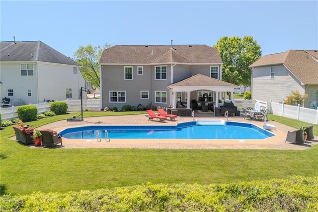view of pool featuring a yard, a patio, a gazebo, and a fenced in pool