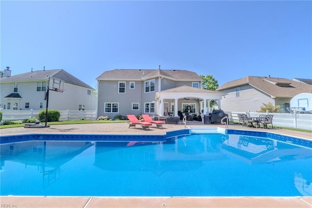 pool with outdoor dining area, ceiling fan, a patio area, and fence