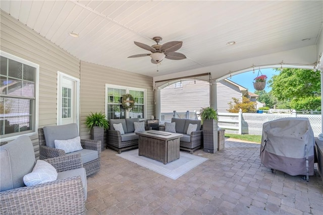 view of patio / terrace with fence, a ceiling fan, an outdoor living space, and area for grilling