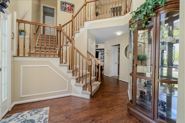 foyer featuring stairs, a wealth of natural light, and wood finished floors