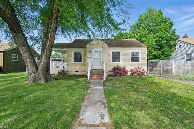 bungalow-style home featuring fence, a front lawn, and crawl space