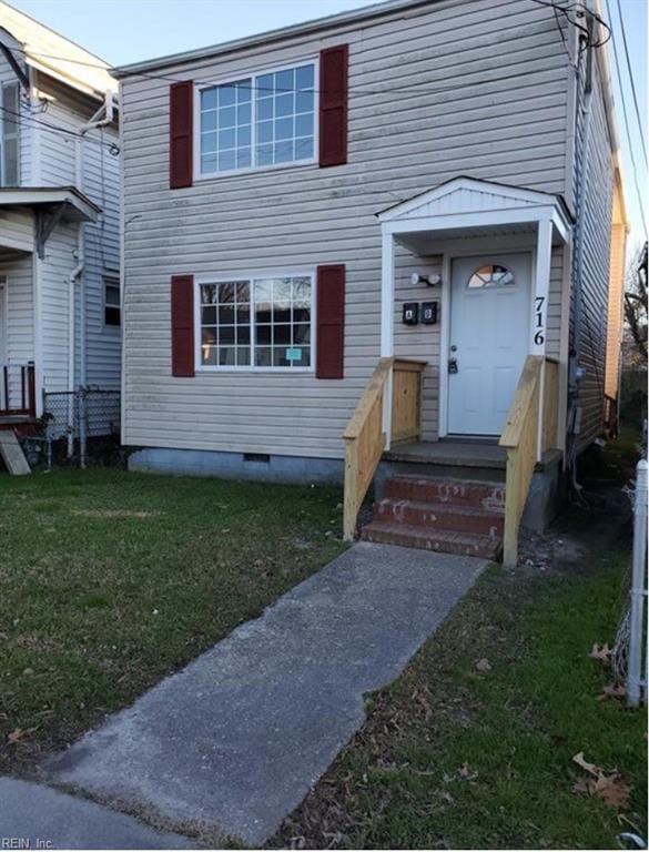 townhome / multi-family property with a front yard, crawl space, and fence