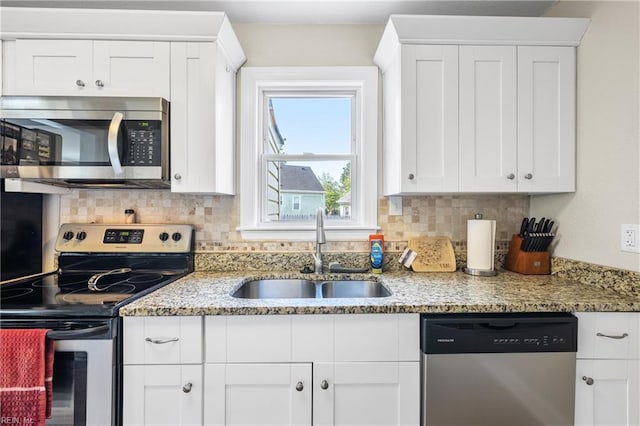 kitchen featuring a sink, appliances with stainless steel finishes, backsplash, and white cabinets
