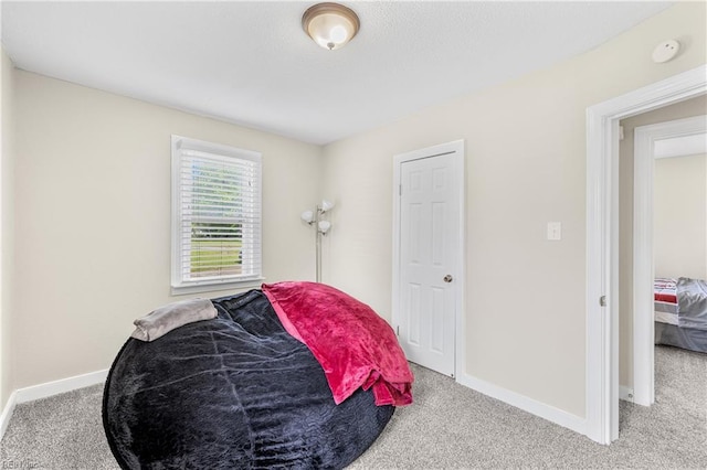 carpeted bedroom with baseboards