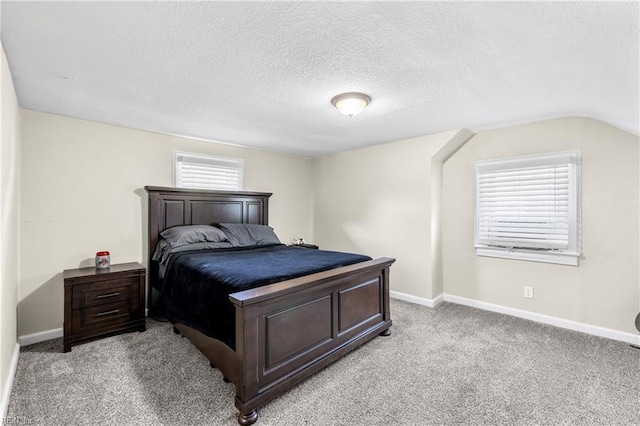 bedroom featuring a textured ceiling, baseboards, light carpet, and lofted ceiling