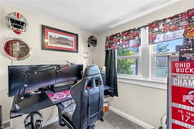 carpeted office space with baseboards and a textured wall