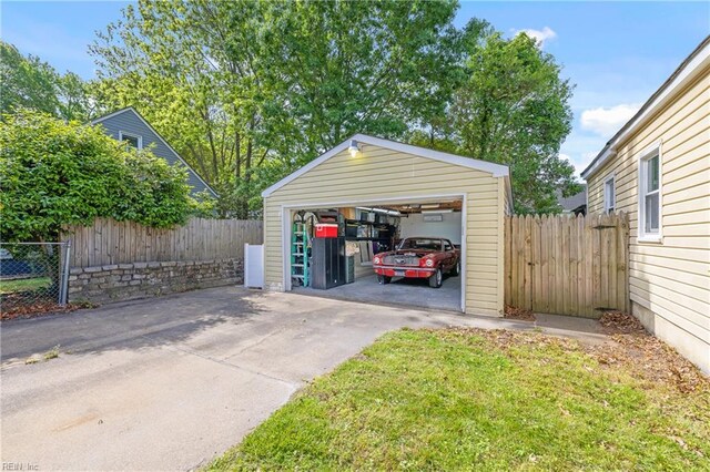 detached garage featuring fence