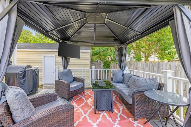 view of patio / terrace featuring an outdoor living space, fence, a gazebo, and a grill