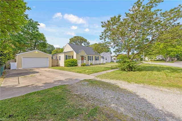 view of front of home with a garage, fence, an outdoor structure, and a front yard