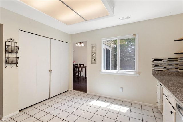 interior space with visible vents, baseboards, light tile patterned flooring, and a closet