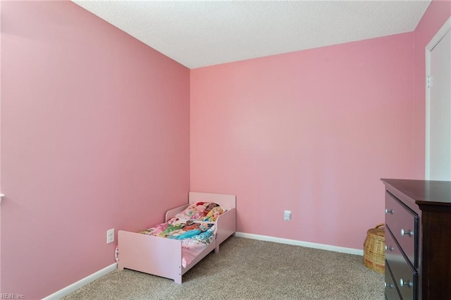 bedroom featuring carpet floors and baseboards