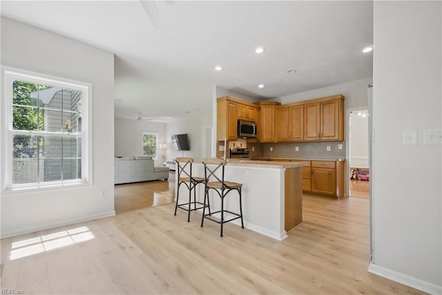 408 Leffler Ln, Virginia Beach, VA 23452 - kitchen featuring open floor plan, a breakfast bar area, stainless steel appliances, and light wood finished floors