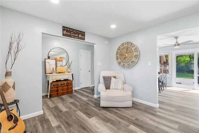 sitting room featuring baseboards, a ceiling fan, wood finished floors, and recessed lighting