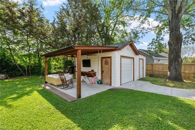 exterior space featuring a ceiling fan, fence, and concrete driveway