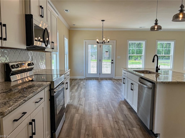 152 Mcpherson Rd, South Mills, NC 27976 - kitchen featuring dark wood finished floors, appliances with stainless steel finishes, ornamental molding, backsplash, and a sink