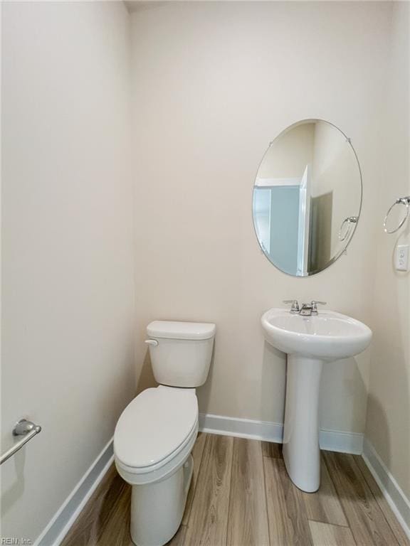 152 Mcpherson Rd, South Mills, NC 27976 - bathroom with baseboards, wood finished floors, and toilet
