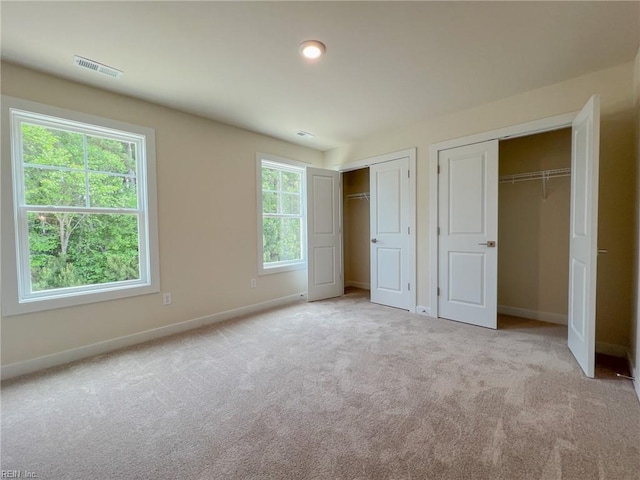 152 Mcpherson Rd, South Mills, NC 27976 - unfurnished bedroom featuring carpet flooring, two closets, baseboards, and visible vents